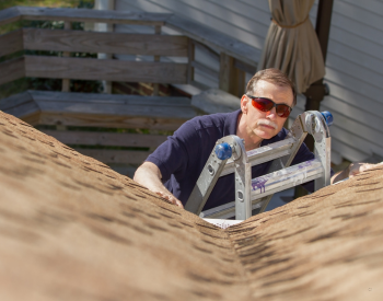 Inspecting a roof in Live Oak, TX for summer maintenance.