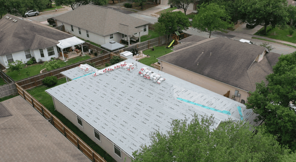 Drone photo of a roof replacement in Schertz during dry-in inspection with underlayment and flashing by Rooftop Roofing and Remodeling.