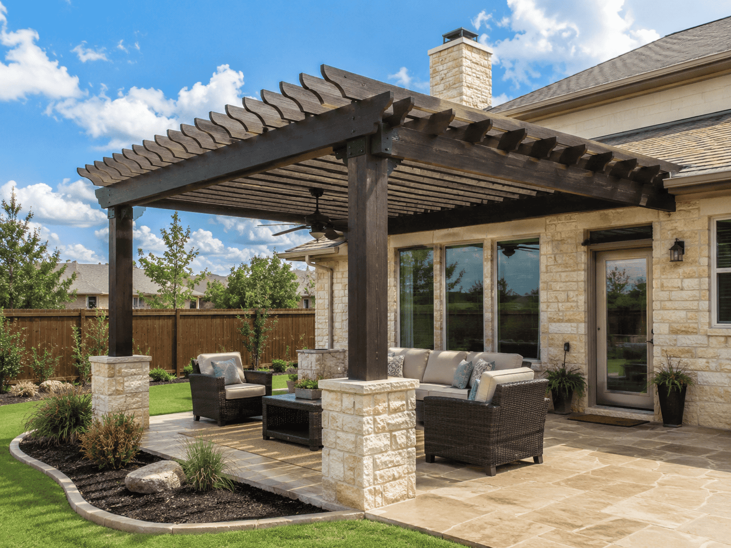 Backyard pergola installation in San Antonio with a covered patio, outdoor seating, and landscaped yard