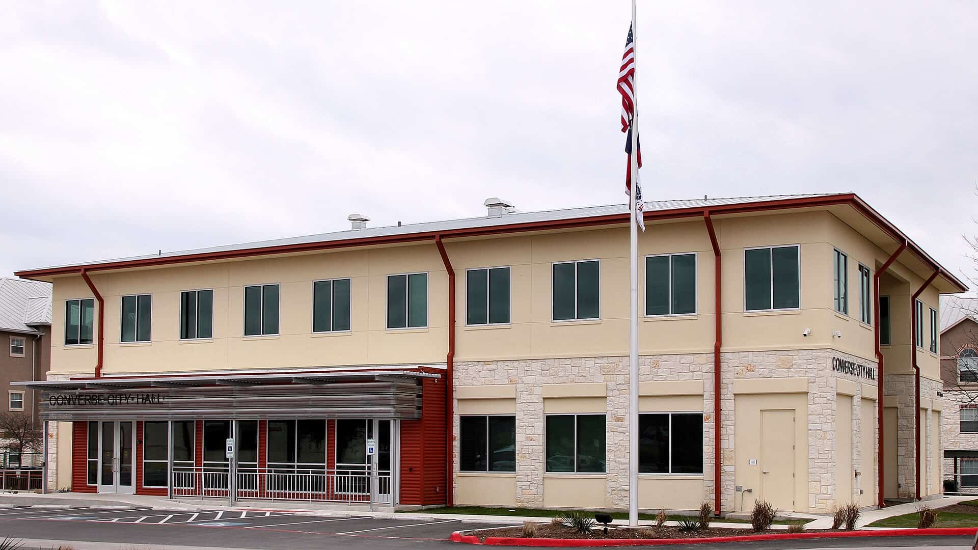 Converse City Hall in Converse, TX, showing its metal roof and American and Texas flags
